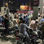 पेट्रोल पंप पर बढ़ती कीमतों के बीच खड़े लोग, जो पाकिस्तान आर्थिक संकट को दर्शाता है